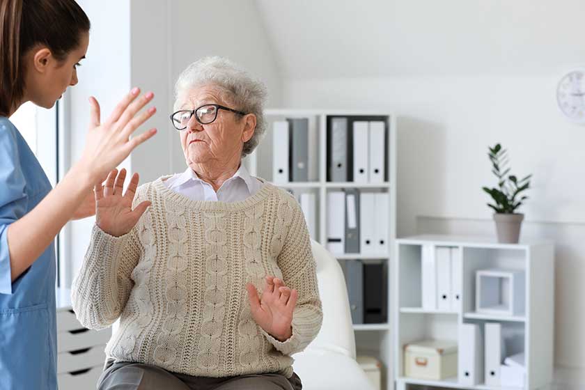 Medical worker mistreating senior woman in nursing home